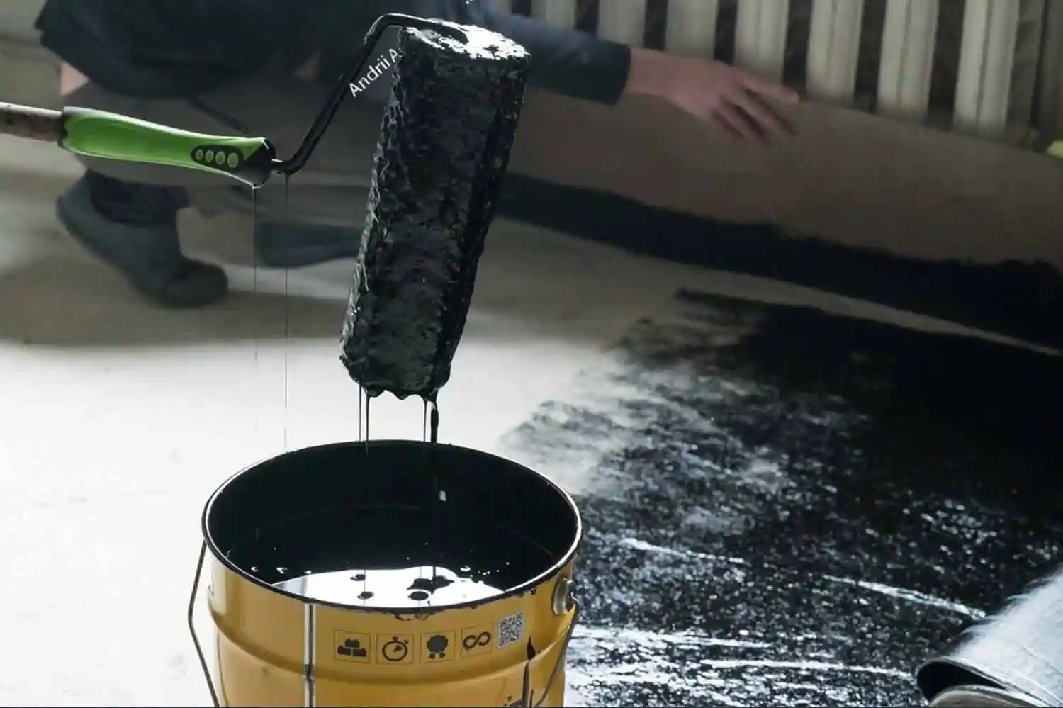applying black paint on floor